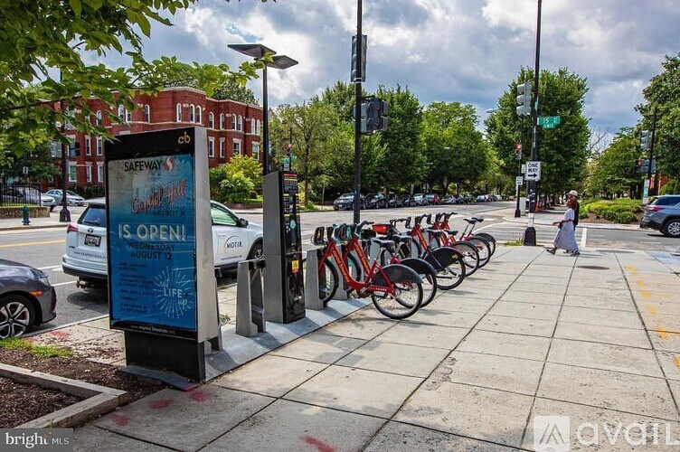 A bike rack with bikes and a sign that says Safeway is open.