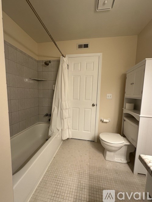 A bathroom with a toilet, tub, and sink.