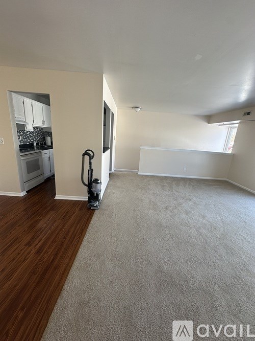 A room with a vacuum cleaner on the floor.