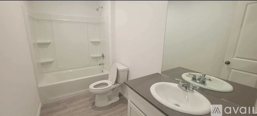 A bathroom with a toilet, sink, and bathtub.