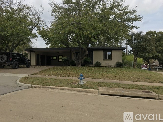 A house with a blue water hydrant in front of it.