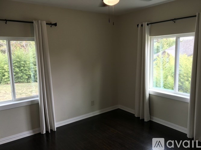 A room with two windows and a ceiling light.