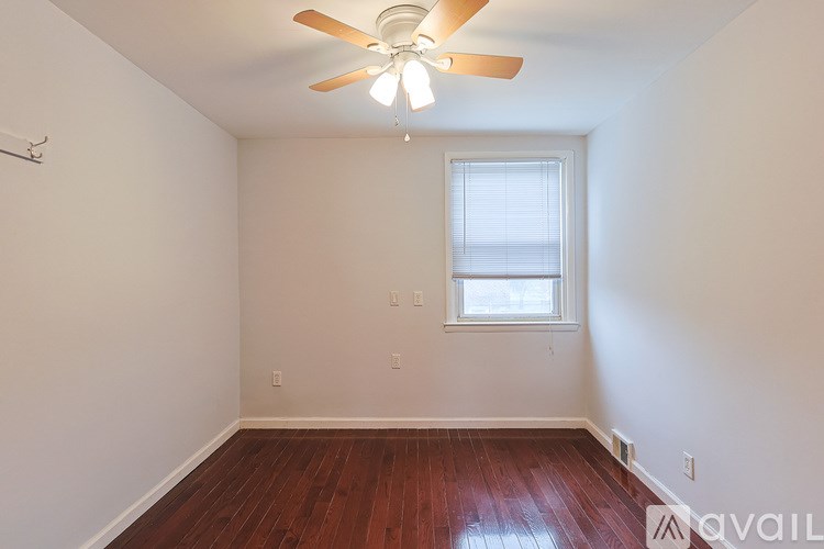 A room with a ceiling fan and a window.