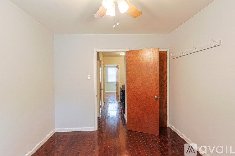 A room with a wooden floor and a ceiling fan.