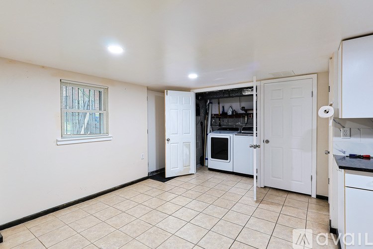 A kitchen area with a white cabinet, a white oven, and a white door.