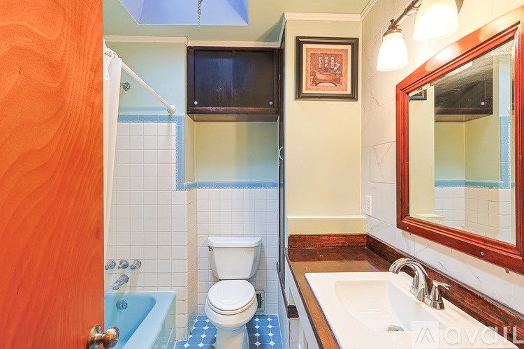 A bathroom with a toilet, sink, and bathtub.