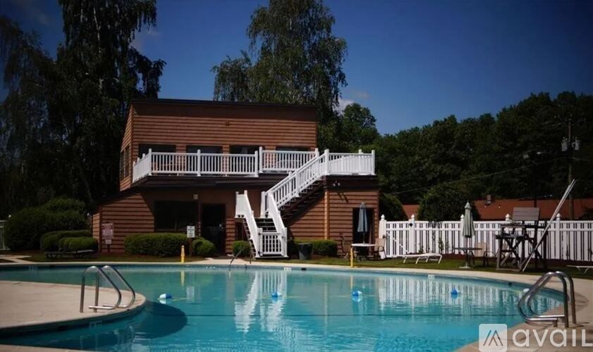 A house with a pool in front of it.
