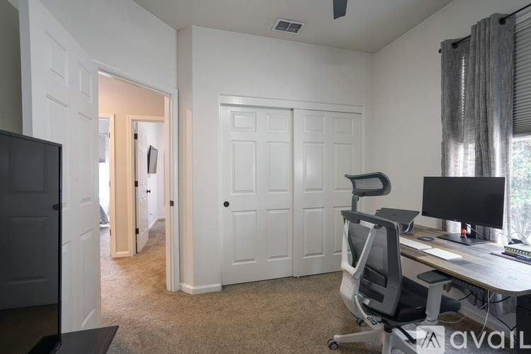 A room with a desk and a chair.