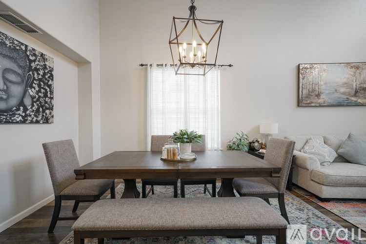 A dining room with a wooden table and chairs.