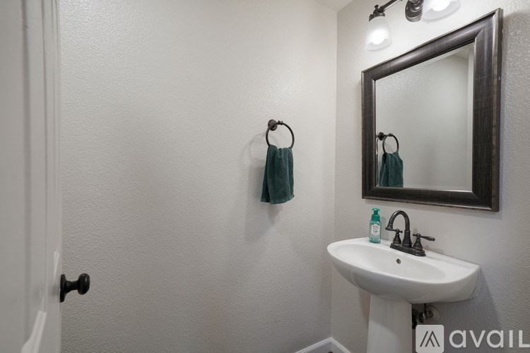 A bathroom with a white sink and a mirror.