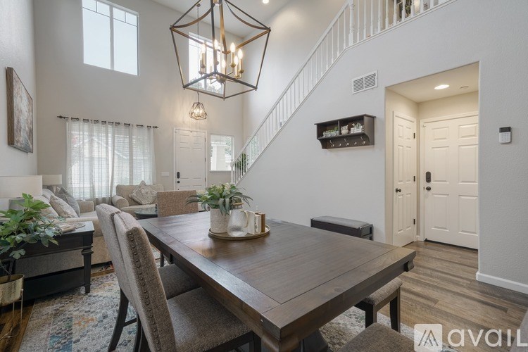 A dining room with a wooden table and chairs.