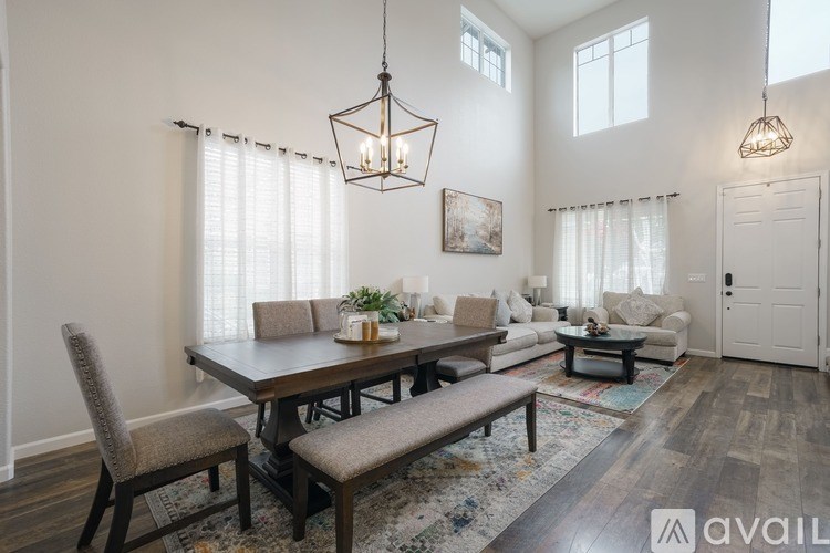A well-lit dining room with a wooden table and chairs.