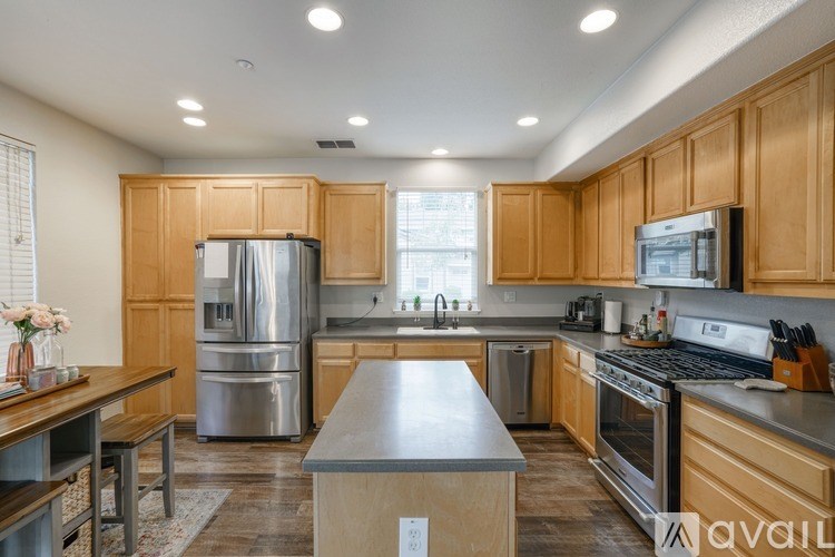 A kitchen with wooden cabinets and stainless steel appliances.