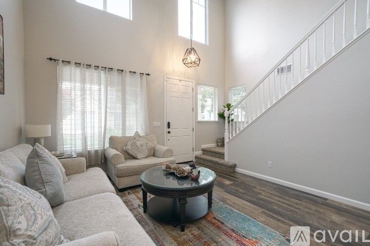 A living room with a grey couch and a coffee table.