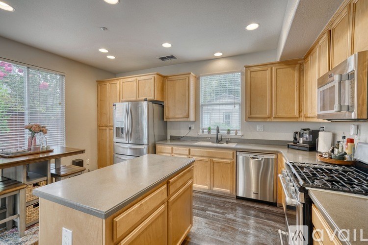 A kitchen with wooden cabinets and stainless steel appliances.