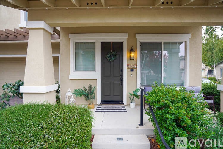 A house with a black door and a glass window is available for rent.