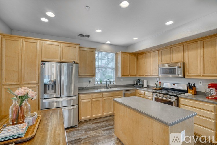 A kitchen with wooden cabinets and stainless steel appliances.