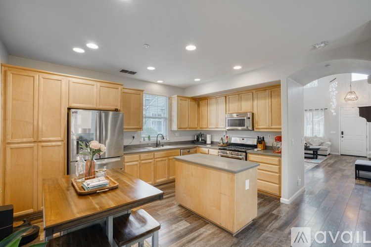 A modern kitchen with wooden cabinets and a center island.