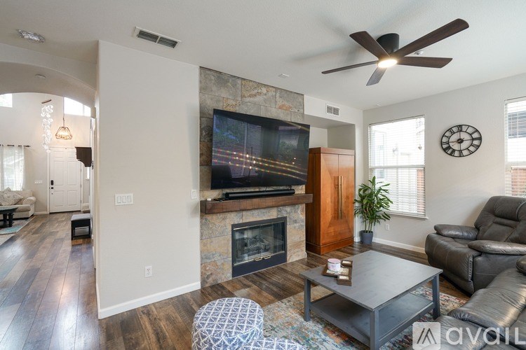 A living room with a fireplace and a television.