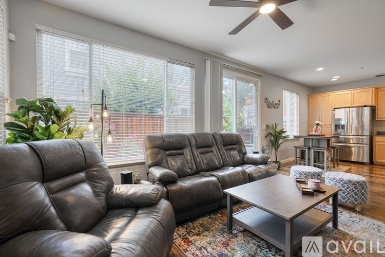 A living room with a large leather sofa and a coffee table.