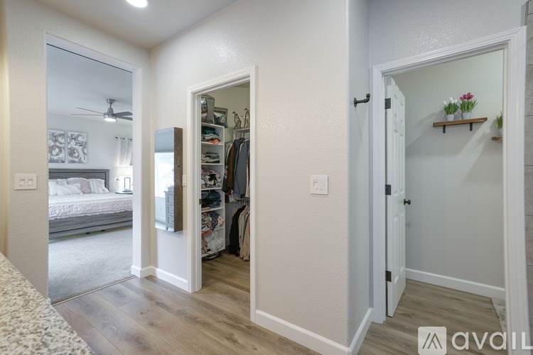 A bedroom with a large closet and a bed in the background.