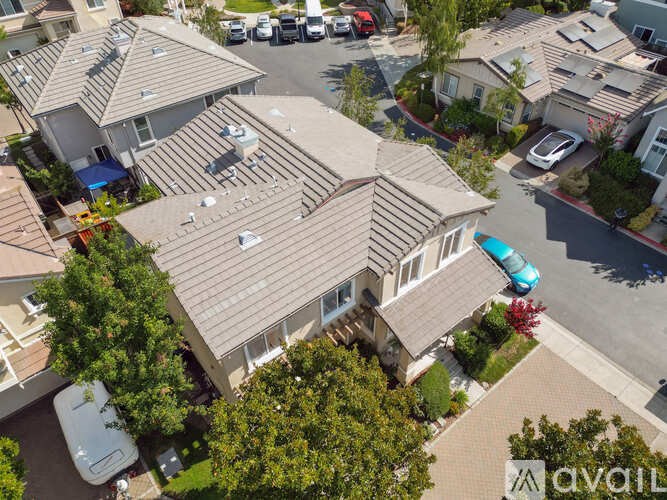 A house with a brown roof and a car parked in front.