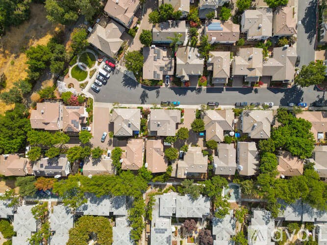 A bird's eye view of a residential neighborhood with houses and trees.