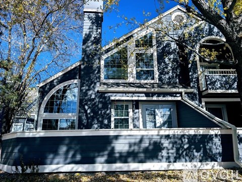 A house with a dark blue exterior and white trim.