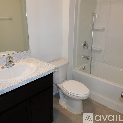 A white toilet sits next to a sink in a bathroom.
