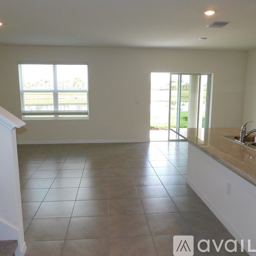 A kitchen with a tiled floor and a window.