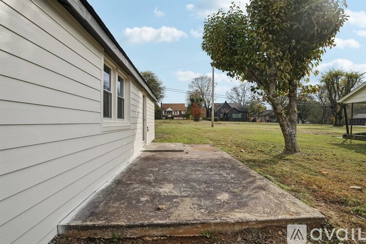 A house with a concrete walkway leading to the front door.