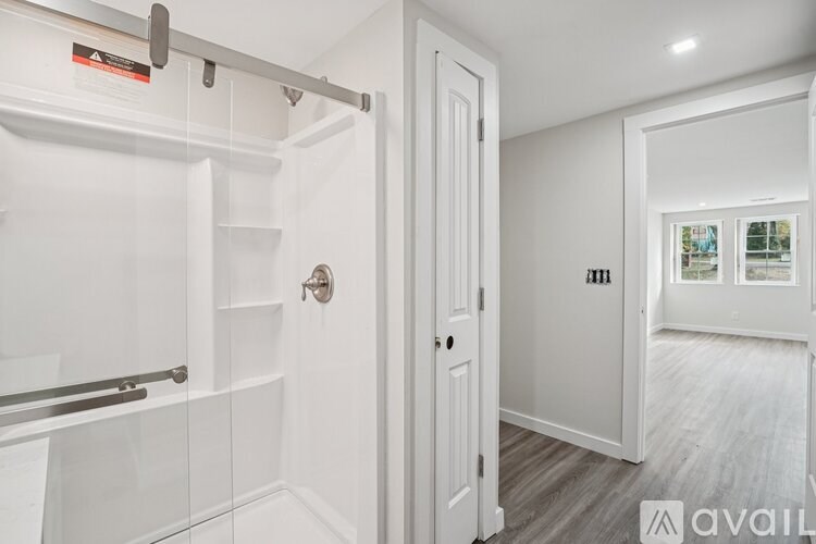 A white door with a handle and a glass window is in a room.