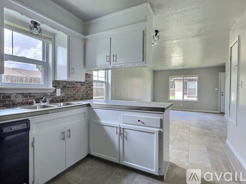 A white bathroom with a sink, toilet, and bathtub.