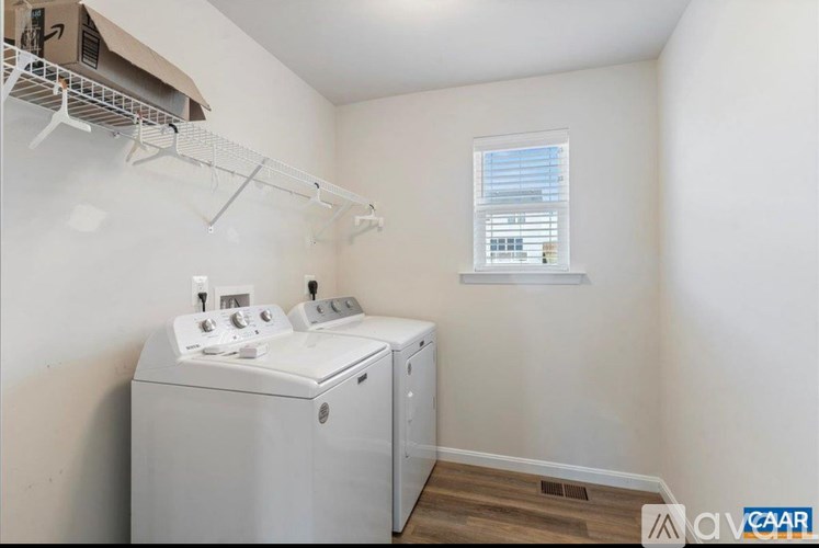 A small laundry room with a washer and dryer.
