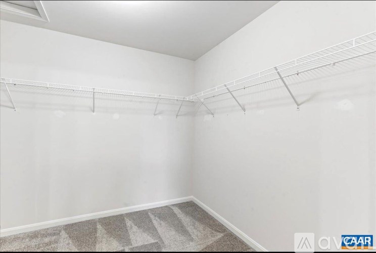 Empty room with a carpeted floor and white walls.