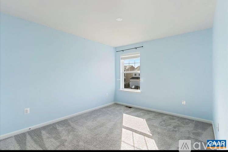 A room with light blue walls and a window.