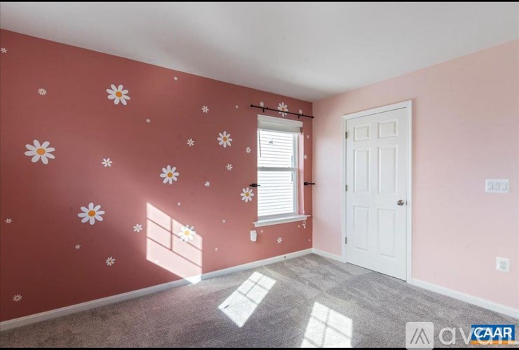 A room with a white door and a window with blinds.