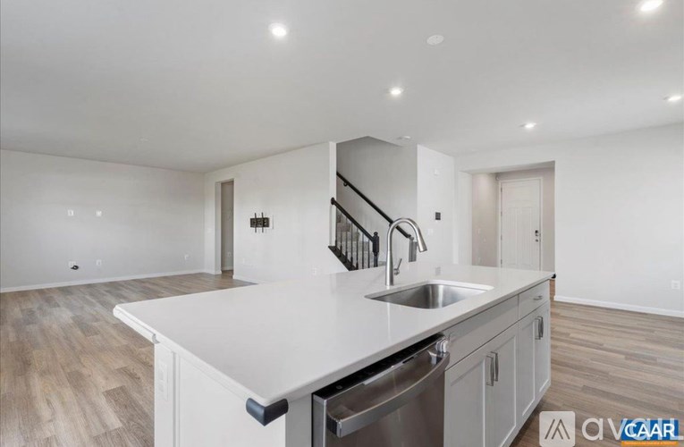 A modern kitchen with a stainless steel dishwasher and a sink.