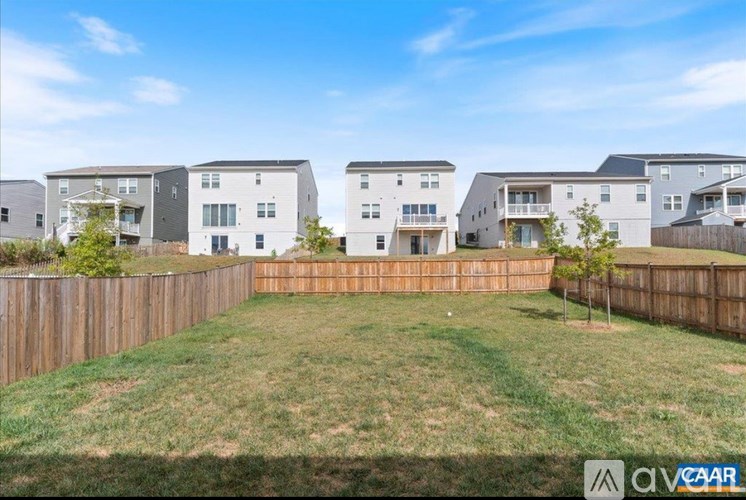 A row of houses with a green lawn in front.