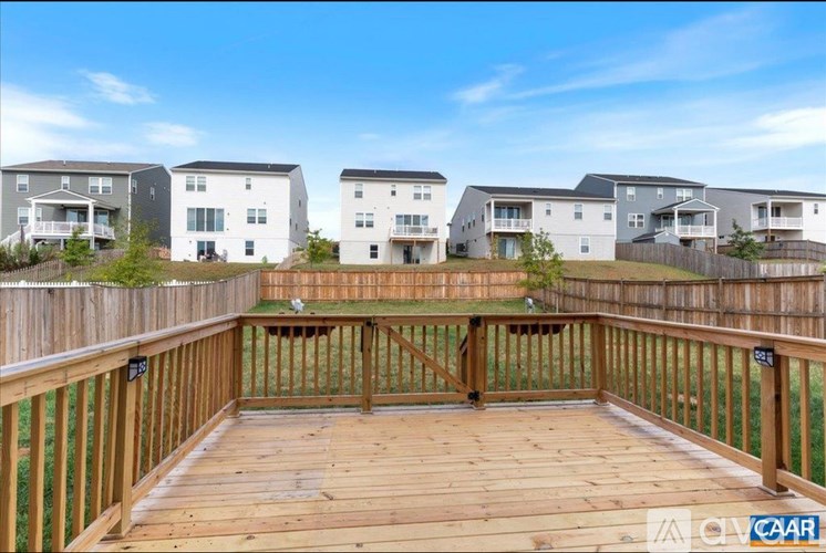 A wooden deck in front of a row of houses.
