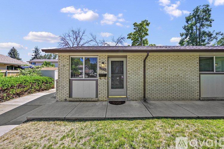 A house with a grey front door and a small window above it.
