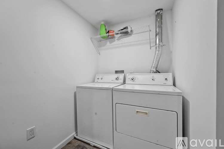 A white washer and dryer in a small laundry room.