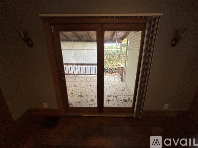 A room with a sliding glass door leading to a patio.