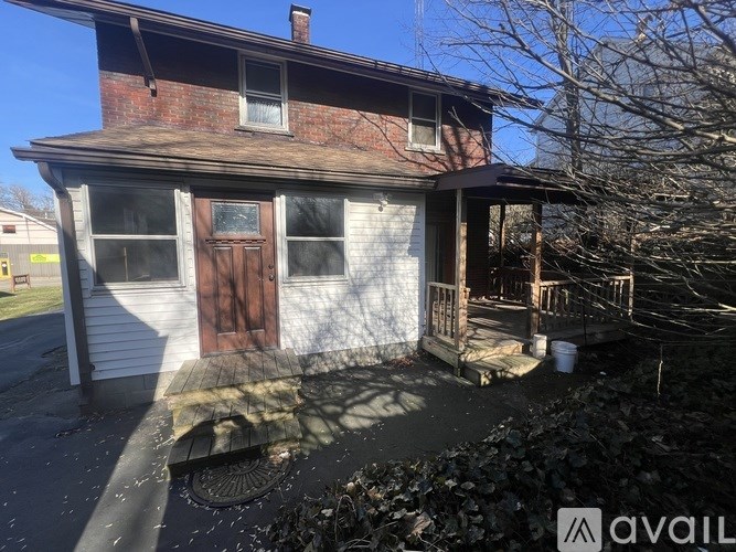 A house with a brown door and a brown roof.