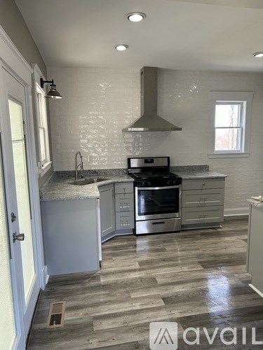 A kitchen with a stove top oven and a sink.