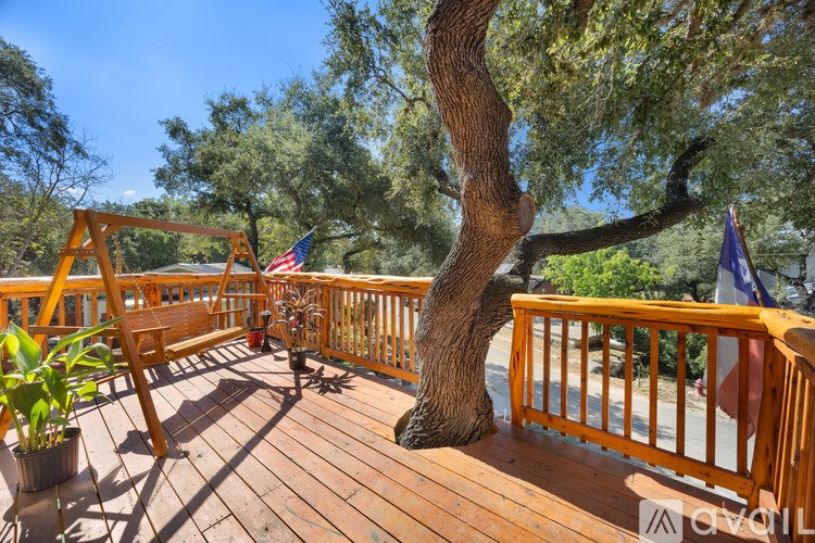 A wooden deck with a tree growing out of it.