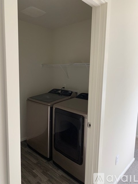 A kitchen with a white oven and microwave.