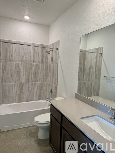 A bathroom with a toilet, sink, and shower.