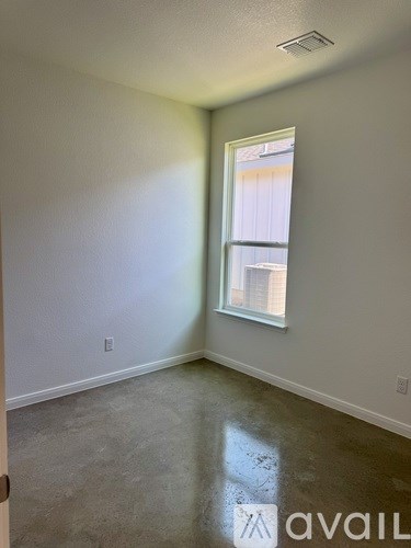 A room with a window and a door.