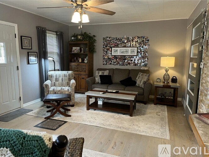 A living room with a chair, a couch, and a coffee table.